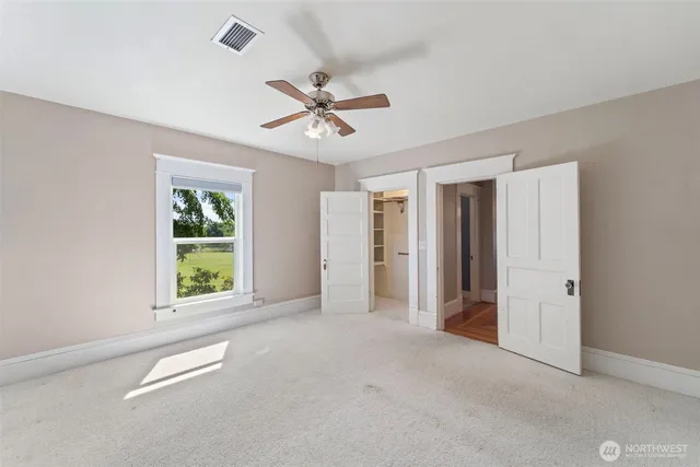 a view of a livingroom with a ceiling fan and window