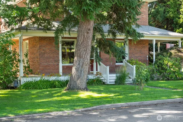 a front view of a house with a yard and a garage