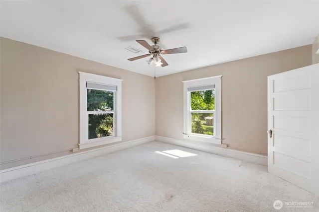 an empty room with windows and closet