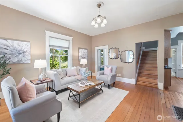 a living room with furniture and wooden floor