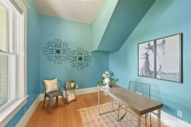 a dining room with furniture and wooden floor