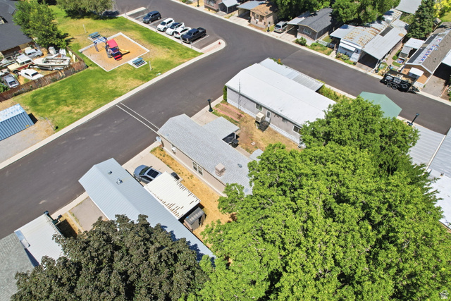 1525 South 400 East, Unit 13 Springville, UT 84663 - Photo 28 of 32 Property featuring a paved road, mature trees, and a nearby community park with play equipment
