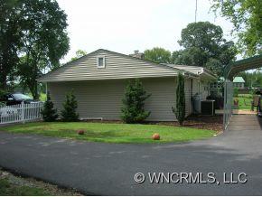 677 Big Island Road Forest City, NC 28043 - Photo 16 of 24 a front view of a house with a yard and garage