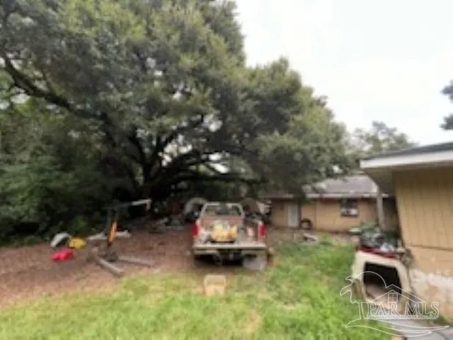 a backyard of a house with table and chairs