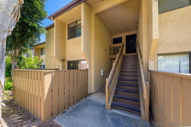 a view of a house with wooden deck