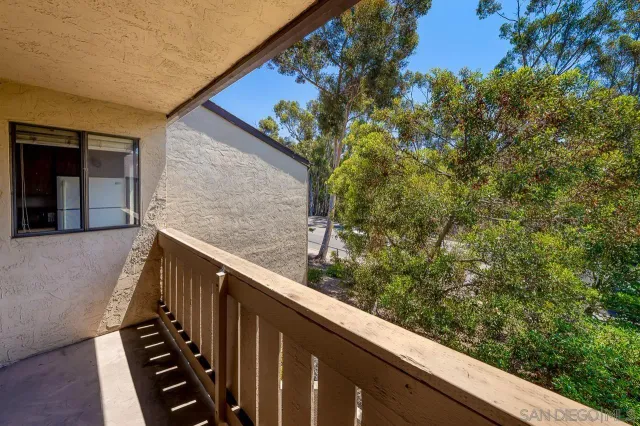 a view of a balcony with wooden fence and floor