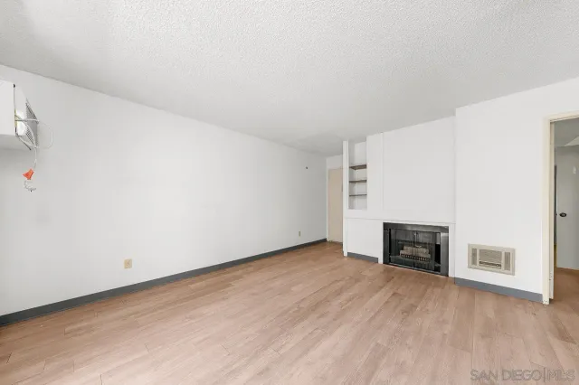 an empty room with furniture and a fireplace