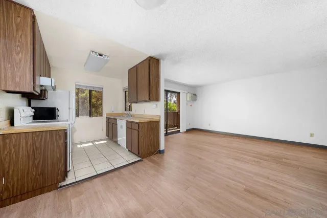 a view of a kitchen with wooden floor and electronic appliances