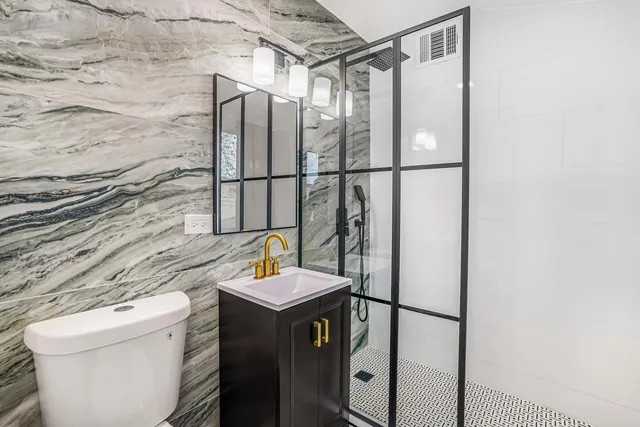a bathroom with a sink toilet and shower