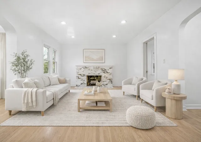 a living room with furniture and a fireplace
