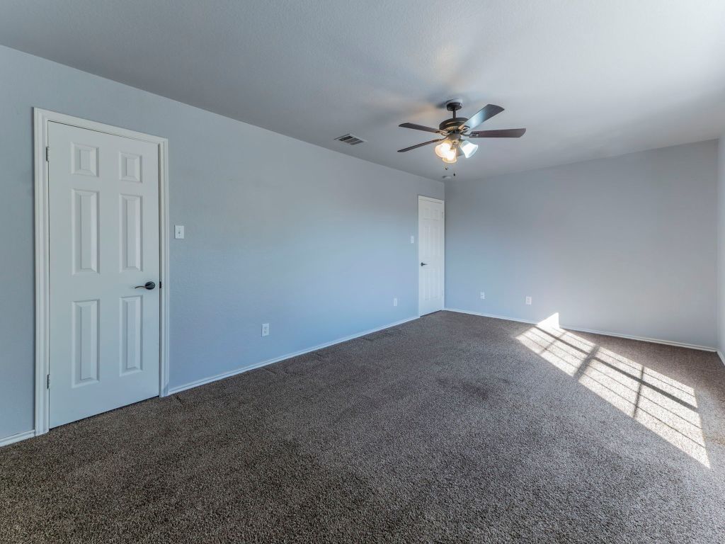 924 Satellite View Round Rock, TX 78665 - Photo 15 of 30 Spare room featuring carpet floors and ceiling fan
