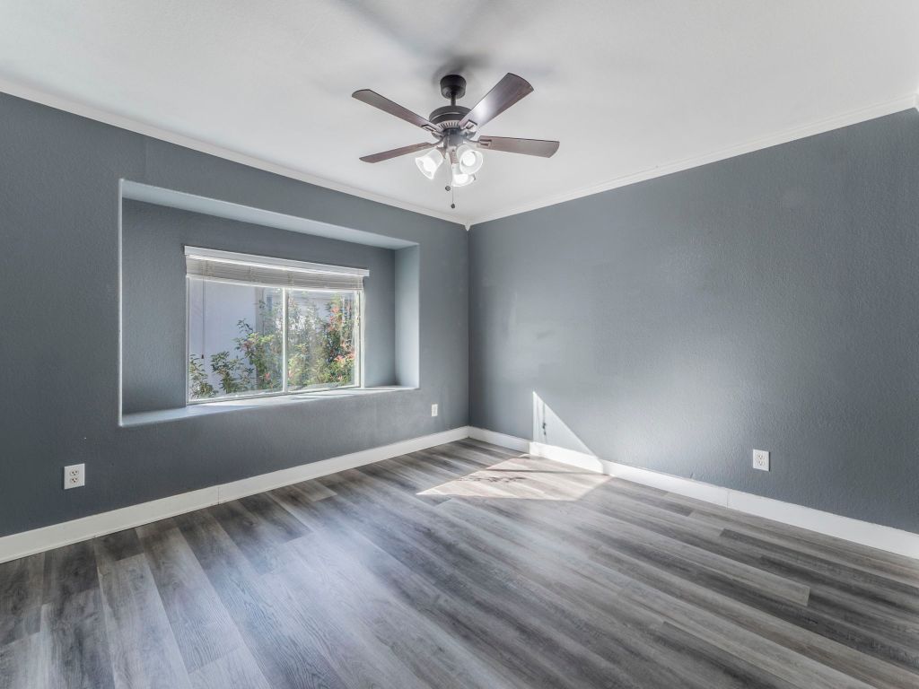 924 Satellite View Round Rock, TX 78665 - Photo 16 of 30 Middle room on garage side featuring ornamental molding, grey lvp finished floors,, and ceiling fan