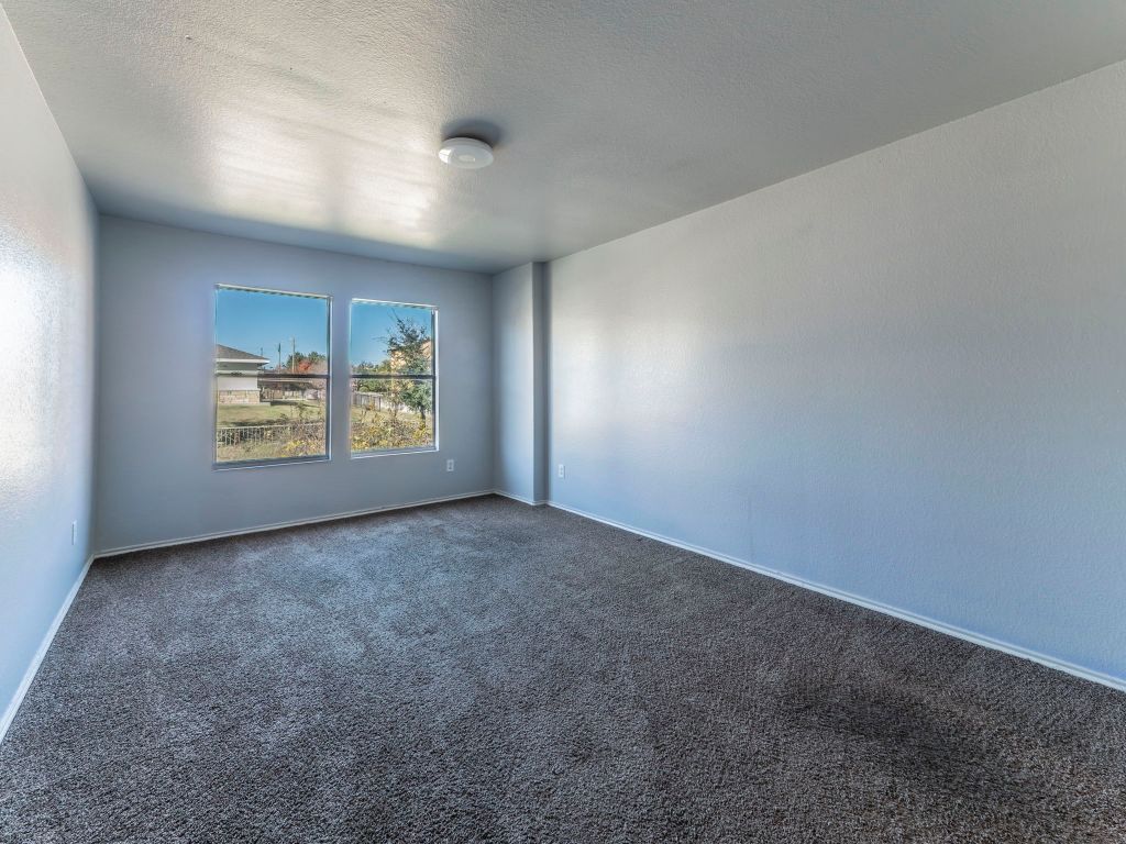 924 Satellite View Round Rock, TX 78665 - Photo 20 of 30 Carpeted spare room featuring a textured ceiling and baseboards
