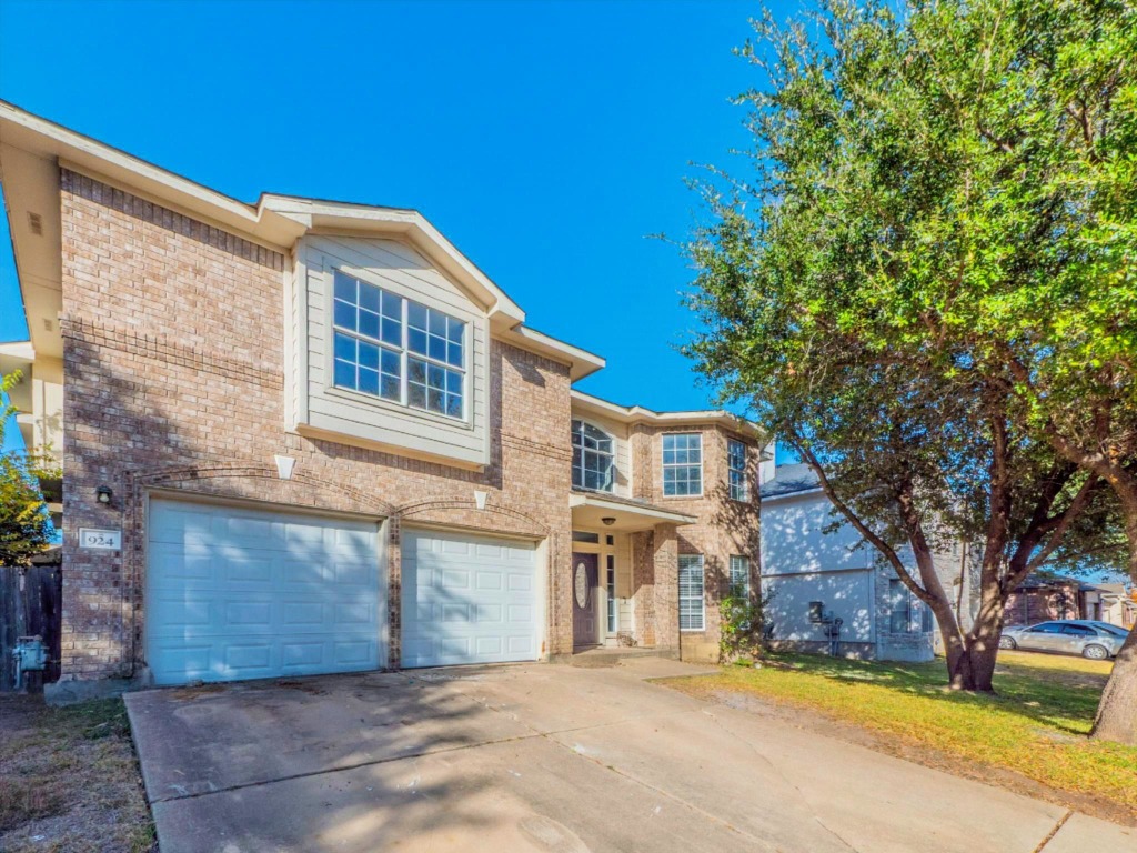 924 Satellite View Round Rock, TX 78665 - Photo 2 of 30 Traditional home with brick siding, concrete driveway, a garage, and a front yard