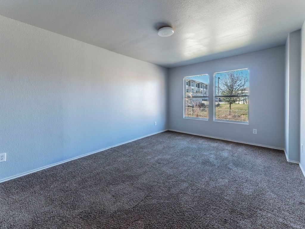924 Satellite View Round Rock, TX 78665 - Photo 21 of 30 Carpeted spare room featuring a textured ceiling and baseboards