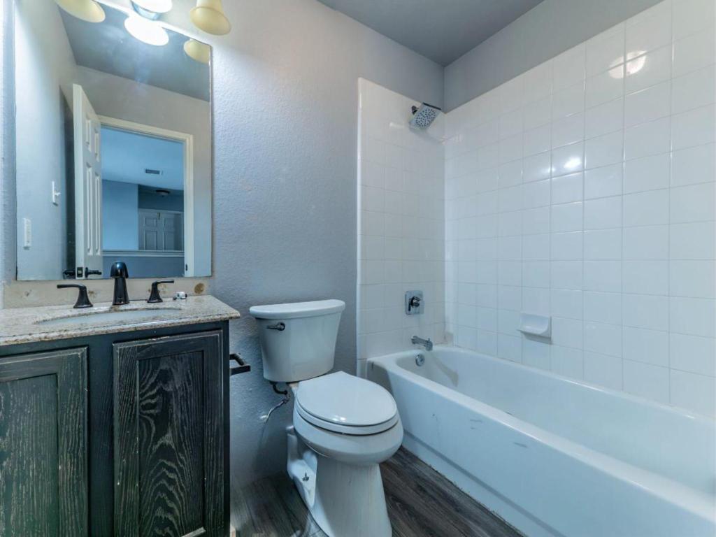 924 Satellite View Round Rock, TX 78665 - Photo 27 of 30 2nd full Bathroom featuring vanity, grey lvp finished floors,, tub / shower combination, and a textured wall