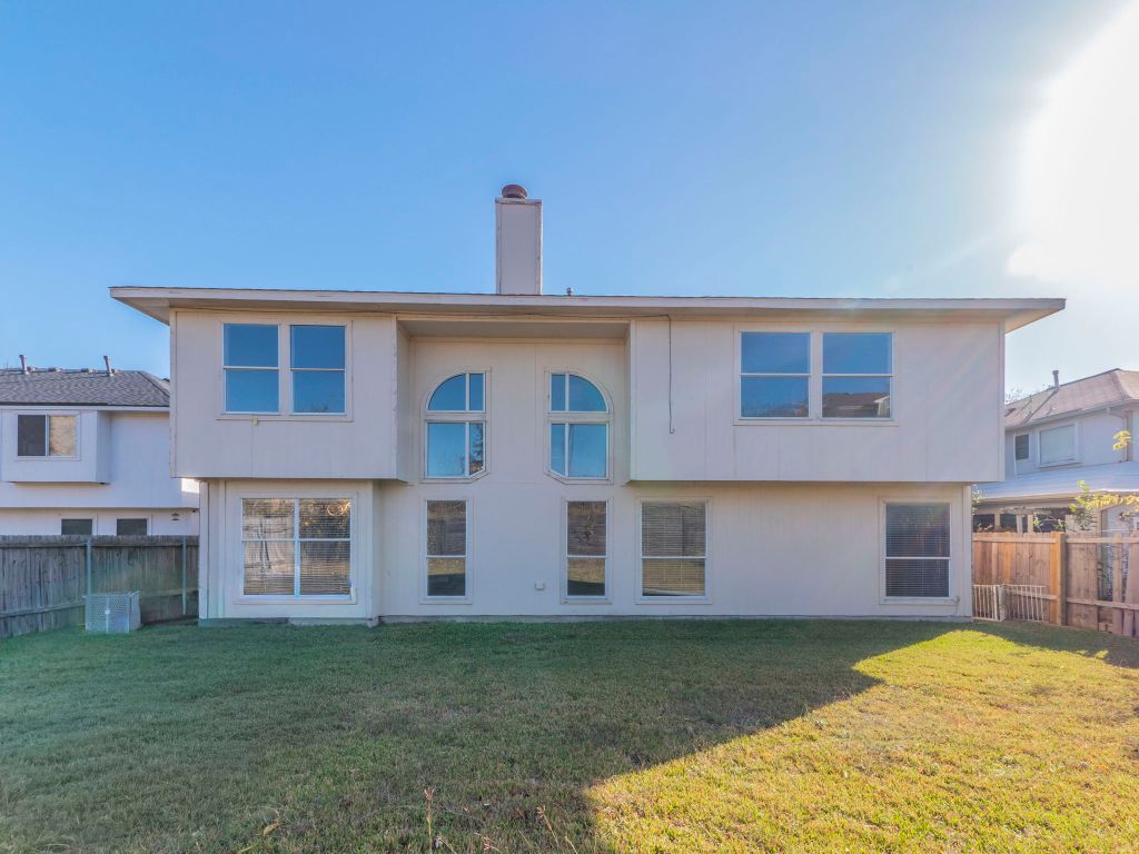 924 Satellite View Round Rock, TX 78665 - Photo 30 of 30 Rear view of house with a fenced backyard and a chimney