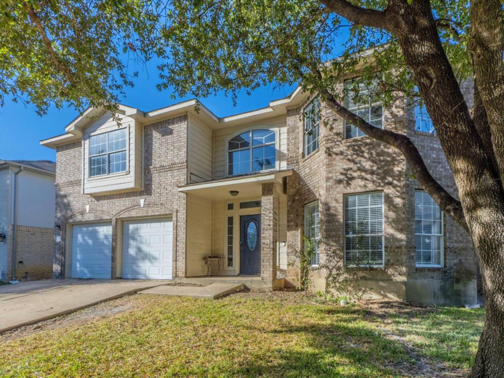 924 Satellite View Round Rock, TX 78665 - Photo 3 of 30 Traditional home featuring a porch, concrete driveway, a garage, brick siding, and a front lawn