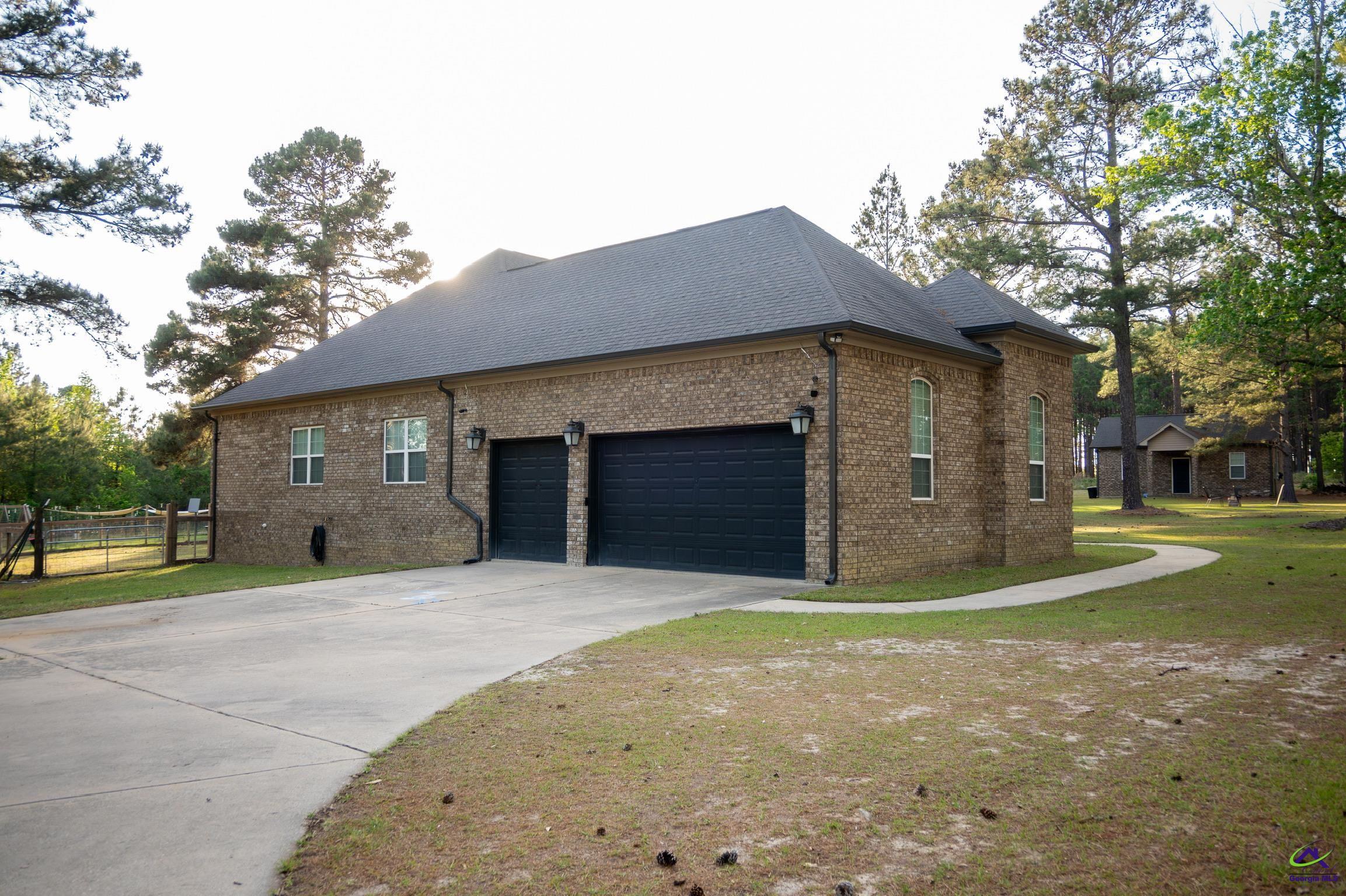 1060 Edna Moore Road Eastman, GA 31023 - Photo 60 of 87 a front view of a house with a yard and garage