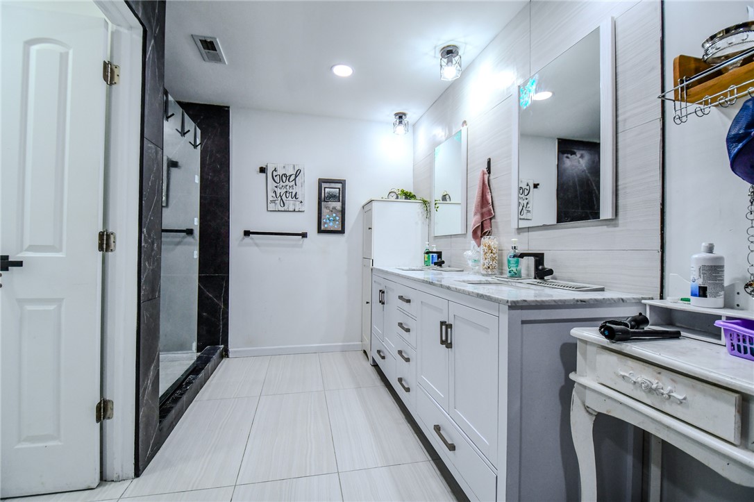 6169 Dayton Farmersville Road Dayton, OH 45417 - Photo 30 of 64 This spacious bathroom features dual vanities and a sleek walk-in shower for daily convenience.