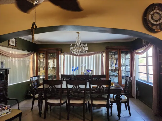 a view of a a dining room with furniture window and wooden floor