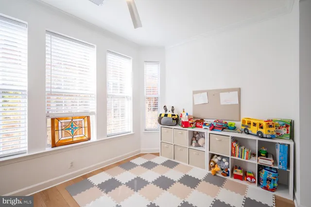 a room with furniture a baby crib and a window