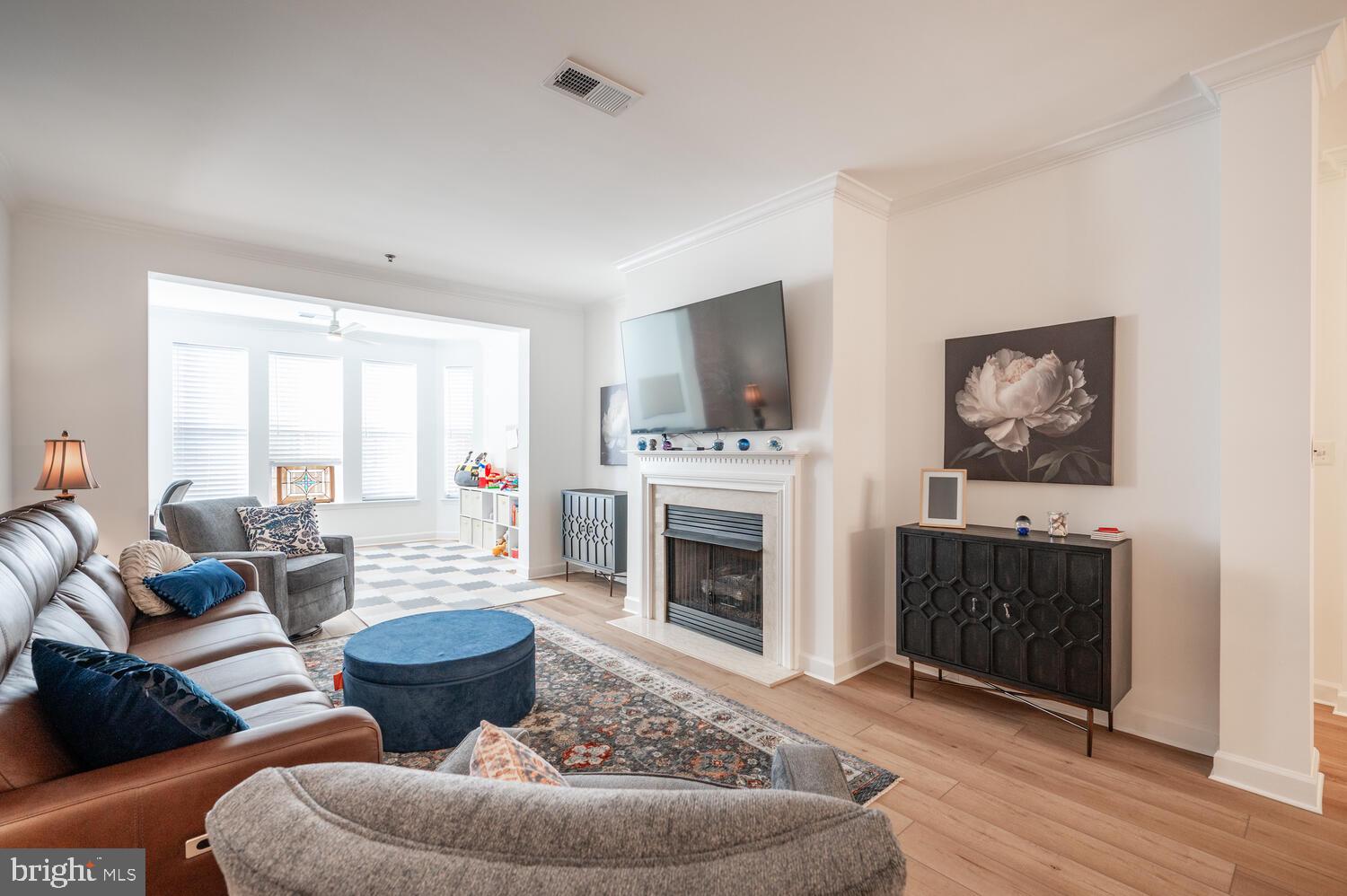 10328 Sager Avenue, Unit 217 Fairfax, VA 22030 - Photo 15 of 42 a living room with furniture a fireplace and a flat screen tv