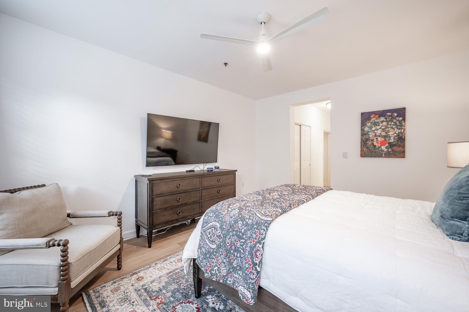 10328 Sager Avenue, Unit 217 Fairfax, VA 22030 - Photo 17 of 42 a bedroom with a bed and a flat screen tv