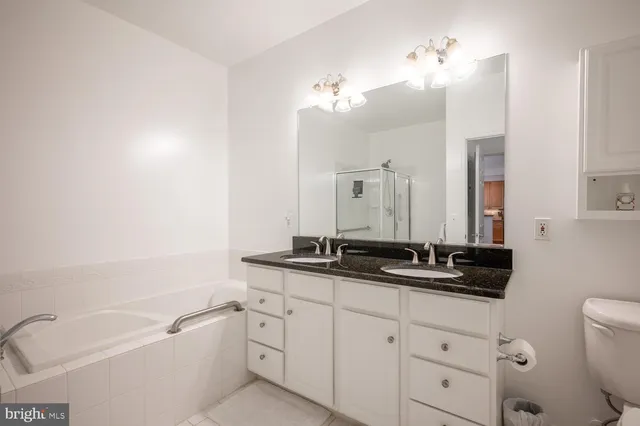 a bathroom with a tub a sink and mirror