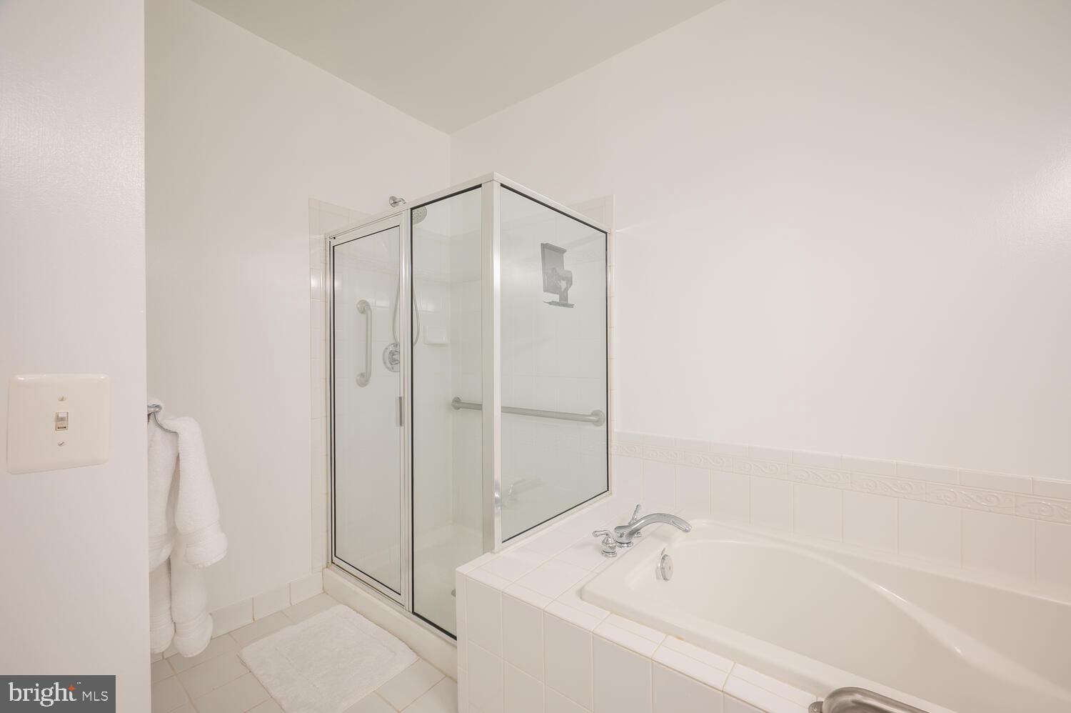 10328 Sager Avenue, Unit 217 Fairfax, VA 22030 - Photo 20 of 42 a bathroom with a bathtub and a shower
