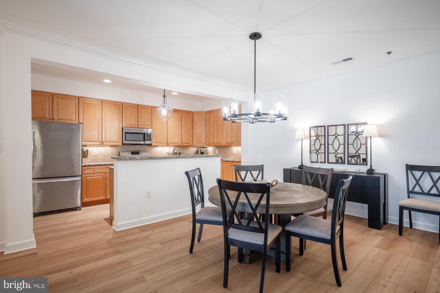 10328 Sager Avenue, Unit 217 Fairfax, VA 22030 - Photo 2 of 42 a view of kitchen with refrigerator a dining table and chairs