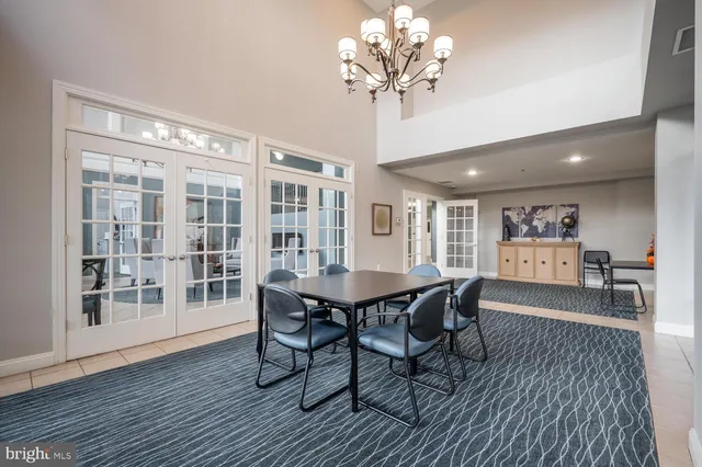 a view of a dining room with furniture wooden floor and chandelier