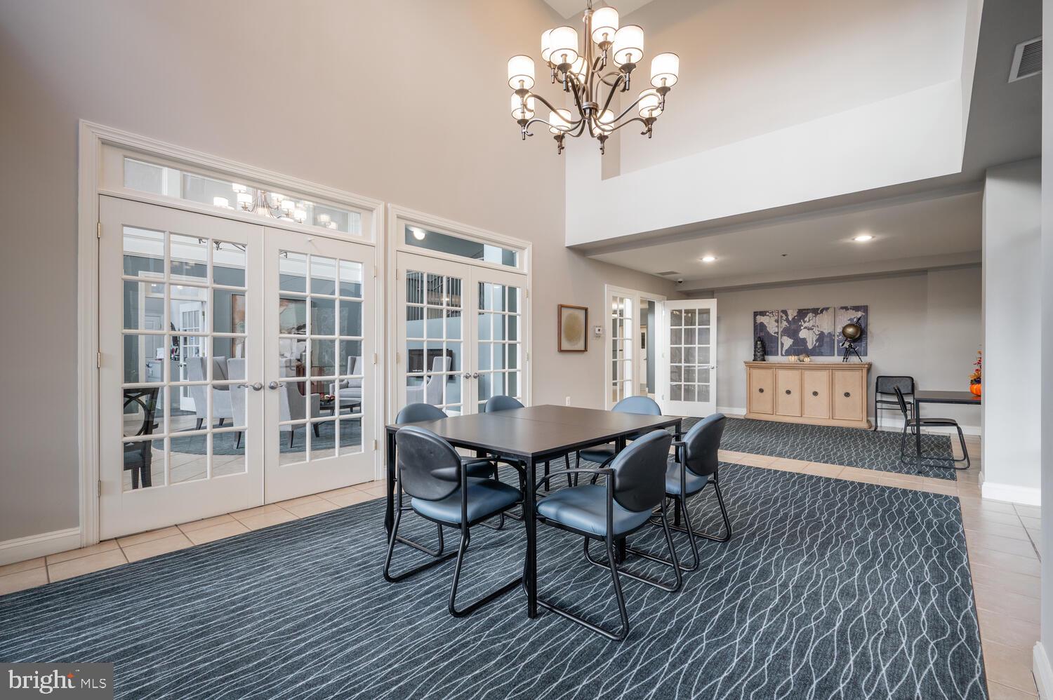 10328 Sager Avenue, Unit 217 Fairfax, VA 22030 - Photo 27 of 42 a view of a dining room with furniture wooden floor and chandelier