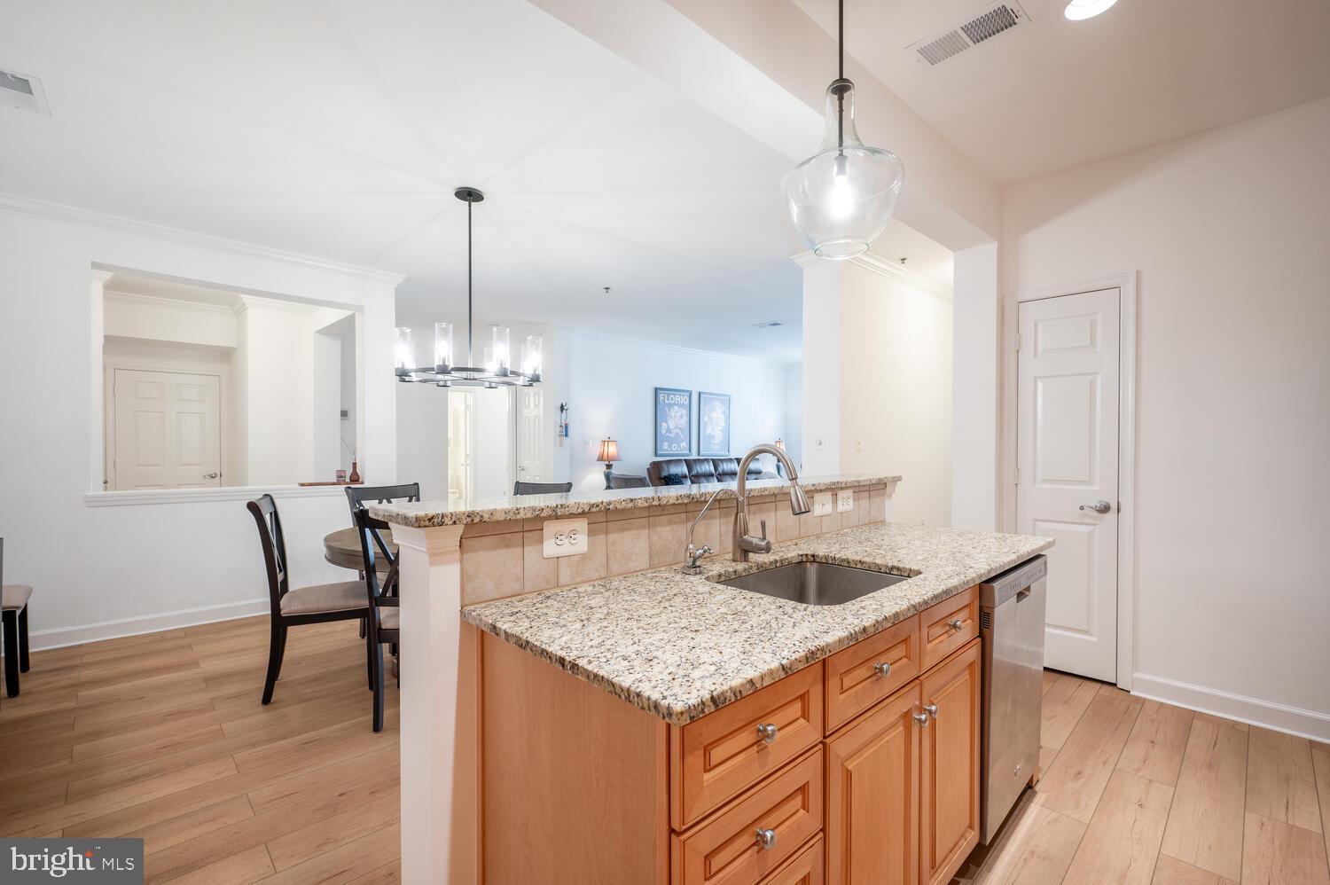 10328 Sager Avenue, Unit 217 Fairfax, VA 22030 - Photo 3 of 42 a kitchen with granite countertop kitchen island stainless steel appliances sink cabinets and wooden floor