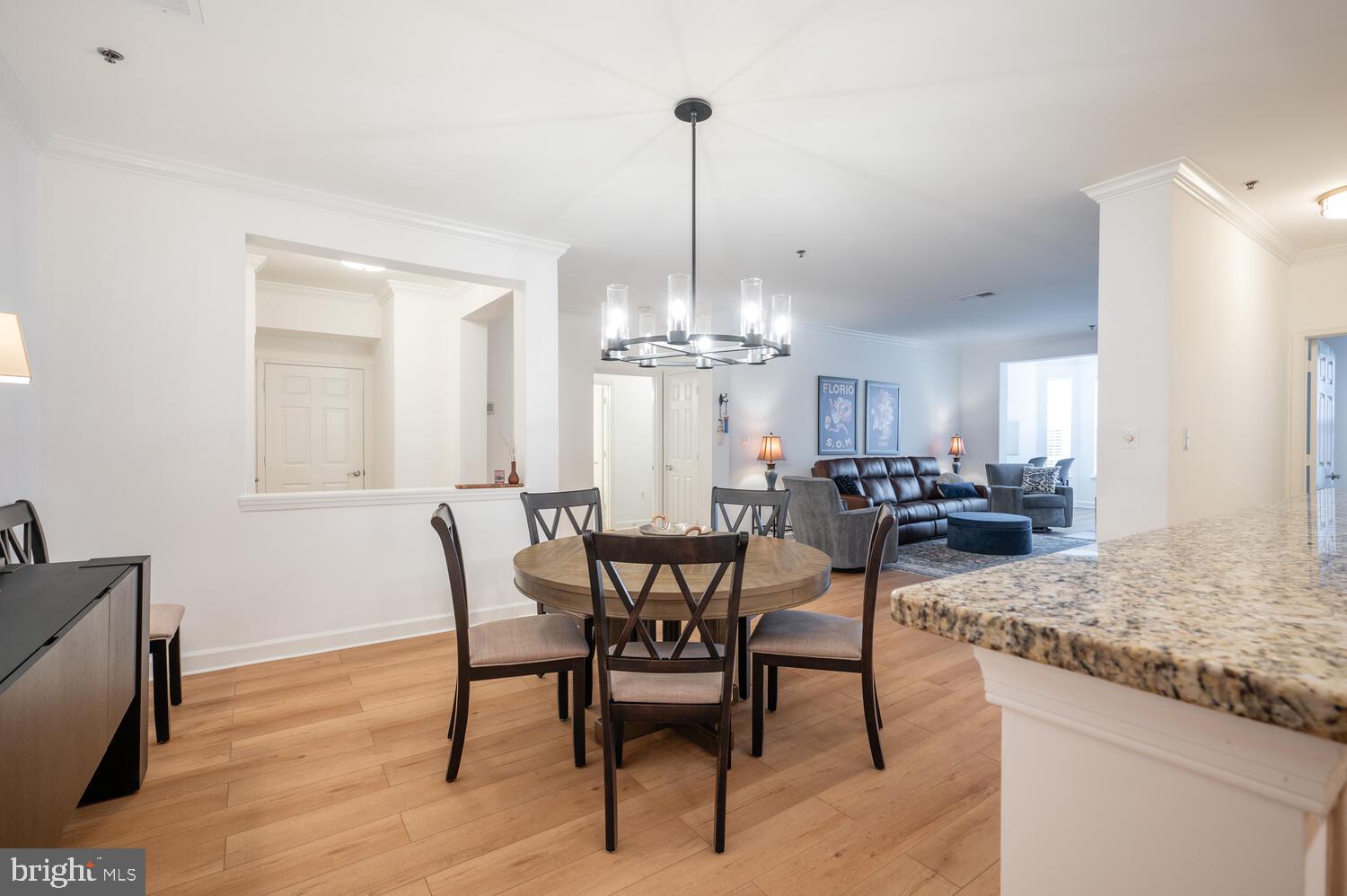 10328 Sager Avenue, Unit 217 Fairfax, VA 22030 - Photo 6 of 42 a view of a dining room with furniture and chandelier