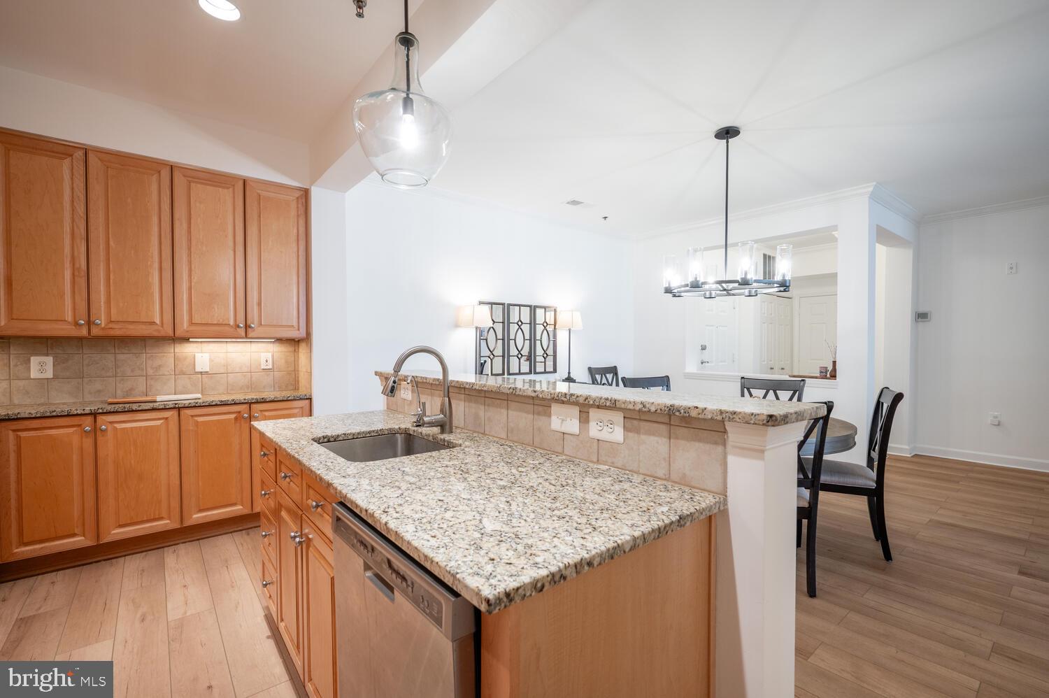 10328 Sager Avenue, Unit 217 Fairfax, VA 22030 - Photo 7 of 42 a kitchen with kitchen island granite countertop a sink a center island and cabinets