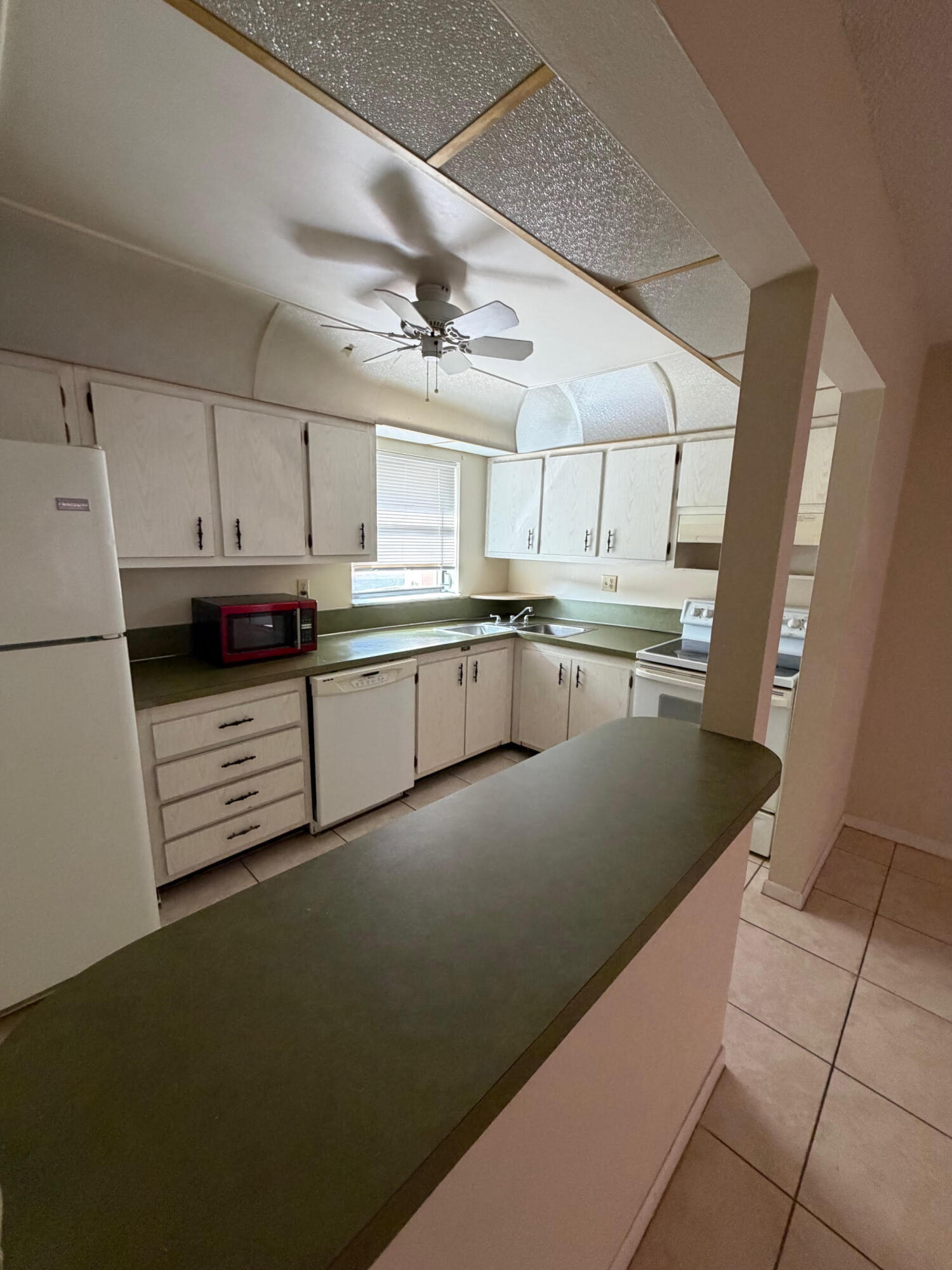 a kitchen with stainless steel appliances granite countertop a sink a stove a refrigerator a microwave and cabinets