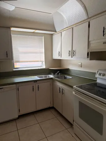 a kitchen with cabinets appliances and a sink