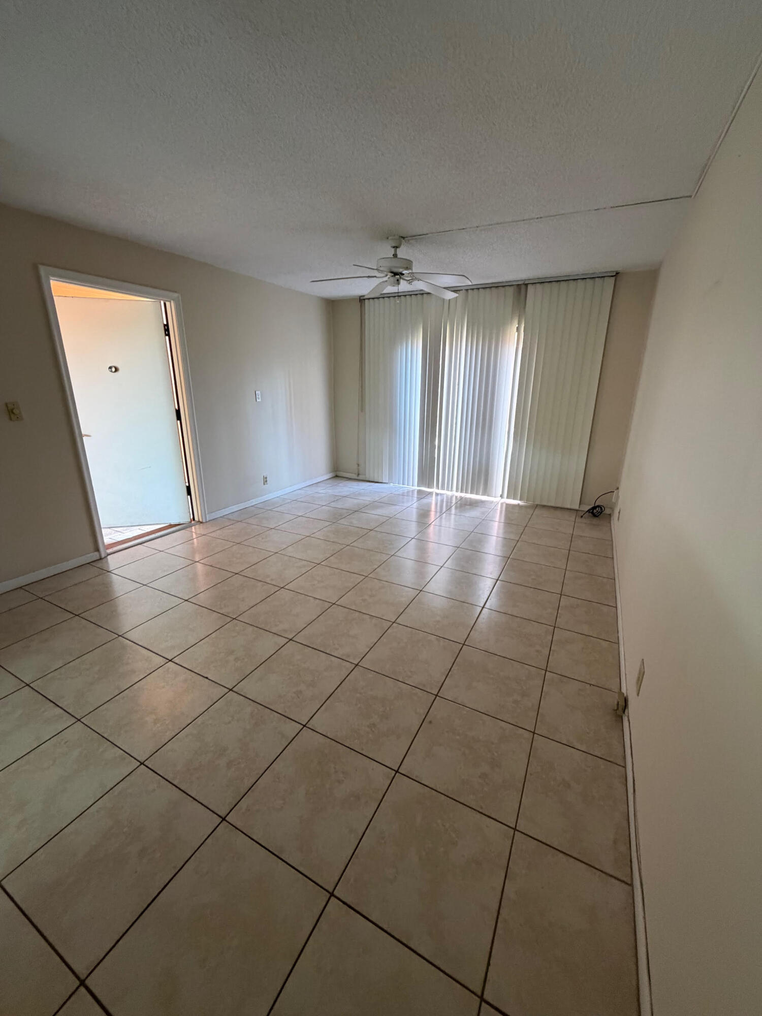 50 Southeast 12th Street, Unit 1520 Boca Raton, FL 33432 - Photo 8 of 14 an empty room with a fireplace and windows