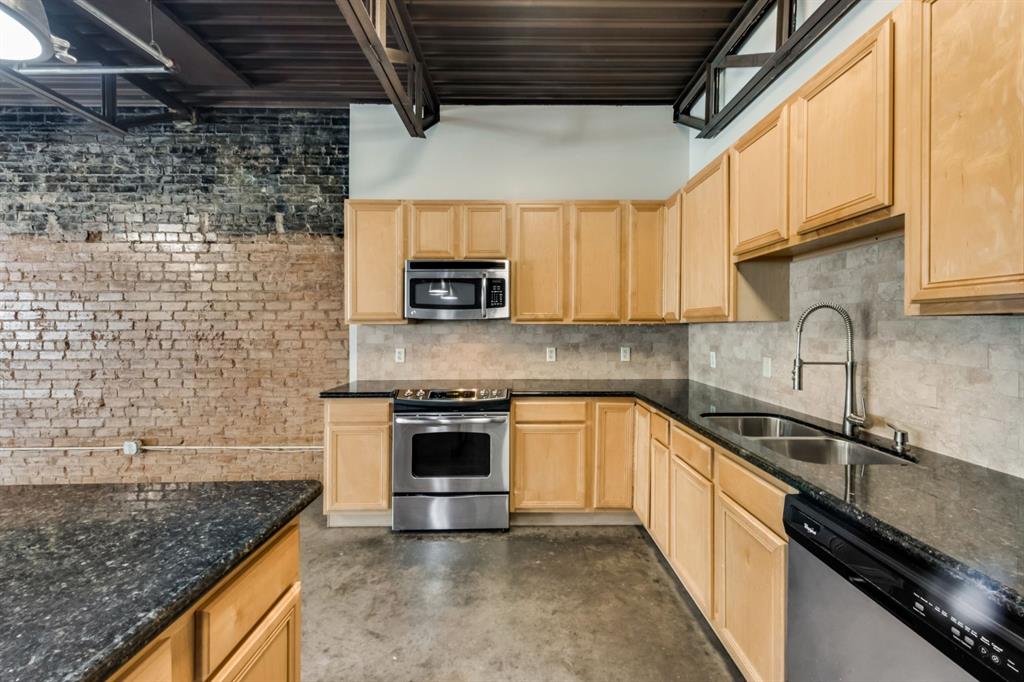 2700 Live Oak Street, Unit 101 Dallas, TX 75204 - Photo 1 of 29 a kitchen with stainless steel appliances granite countertop a sink a stove and a microwave