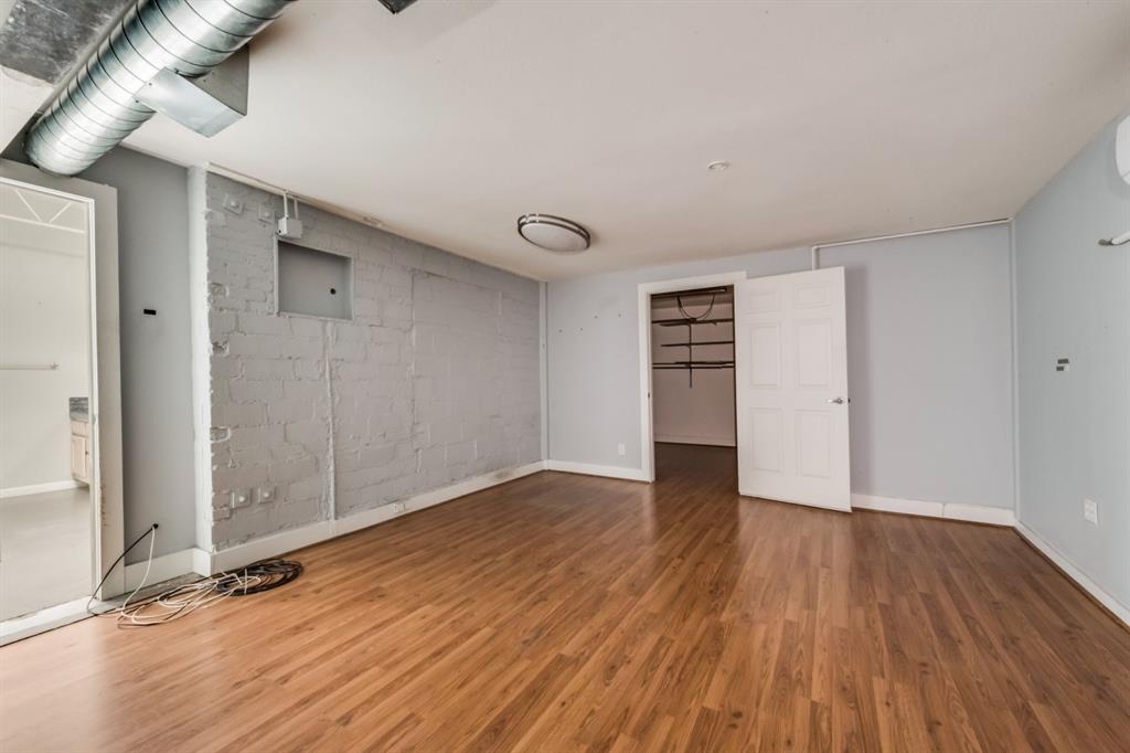 2700 Live Oak Street, Unit 101 Dallas, TX 75204 - Photo 3 of 29 a view of an empty room with wooden floor and closet
