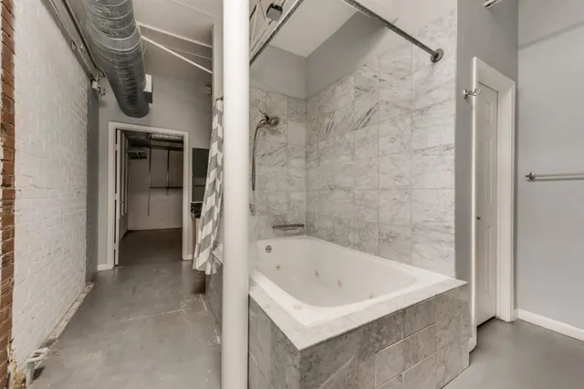 a bathroom with a bathtub and a shower