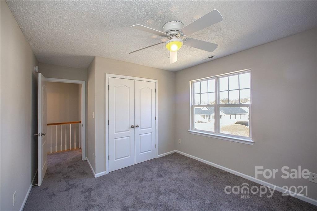881 Raindrops Road Gastonia, NC 28054 - Photo 12 of 25 an empty room with windows and ceiling fan