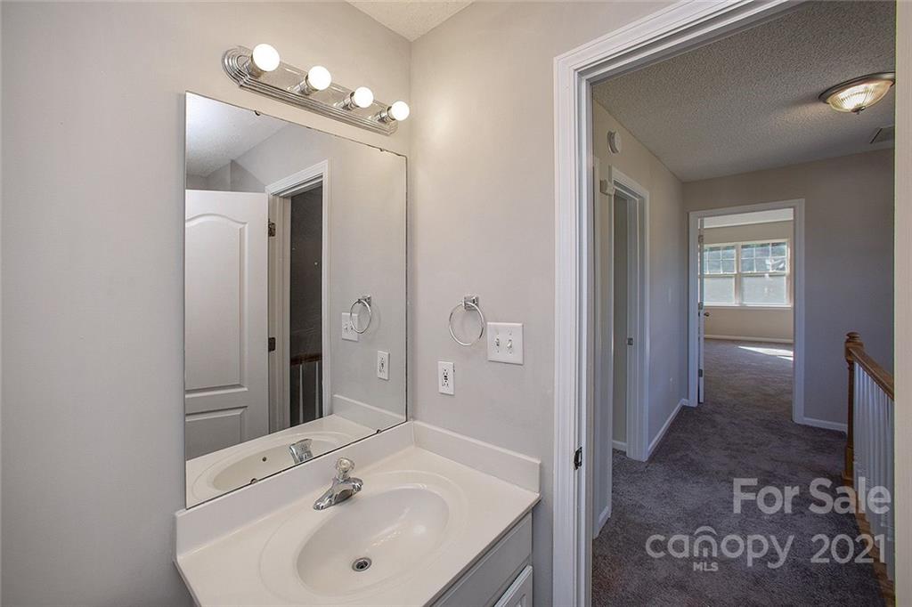 881 Raindrops Road Gastonia, NC 28054 - Photo 13 of 25 a bathroom with a sink and a mirror