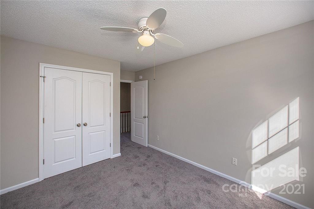 881 Raindrops Road Gastonia, NC 28054 - Photo 22 of 25 an empty room with closet and ceiling fan