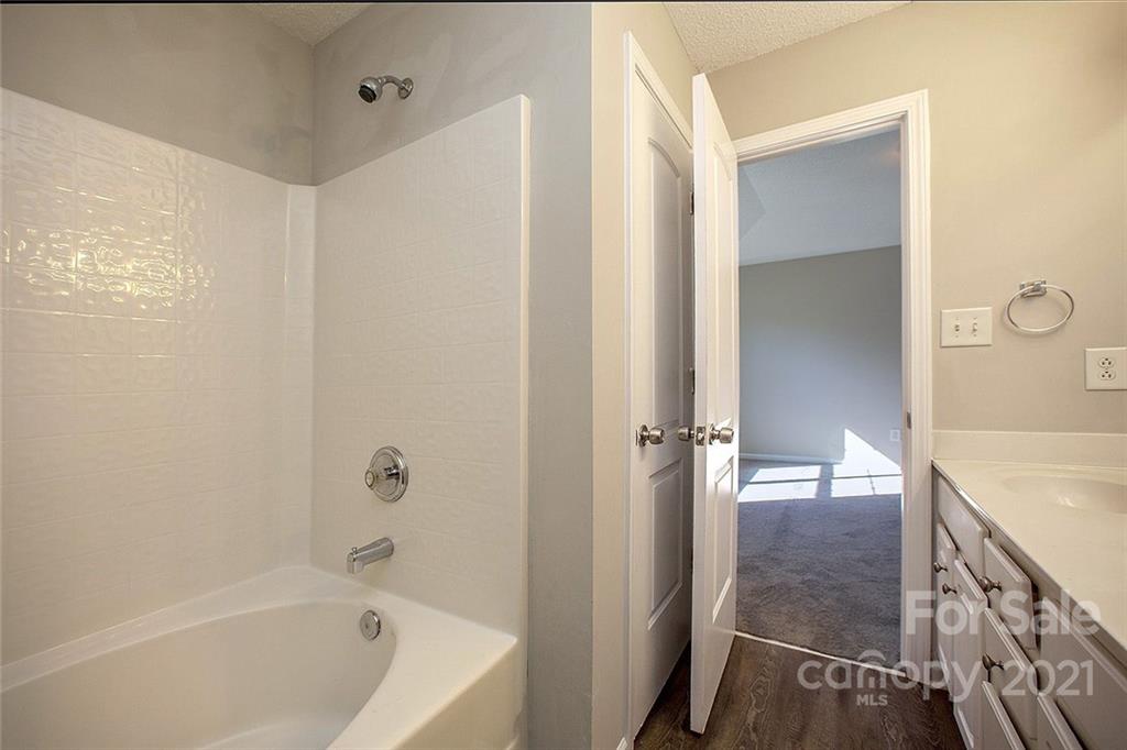 881 Raindrops Road Gastonia, NC 28054 - Photo 25 of 25 a bathroom with a tub shower vanity and a sink