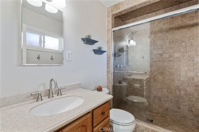 a bathroom with a sink mirror vanity and toilet