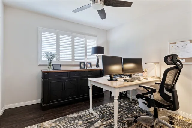 a bathroom with a granite countertop sink vanity mirror and toilet