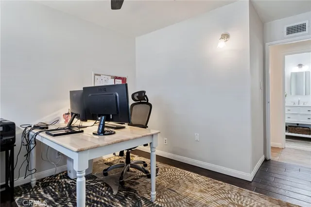 a bedroom with a bed table and a window