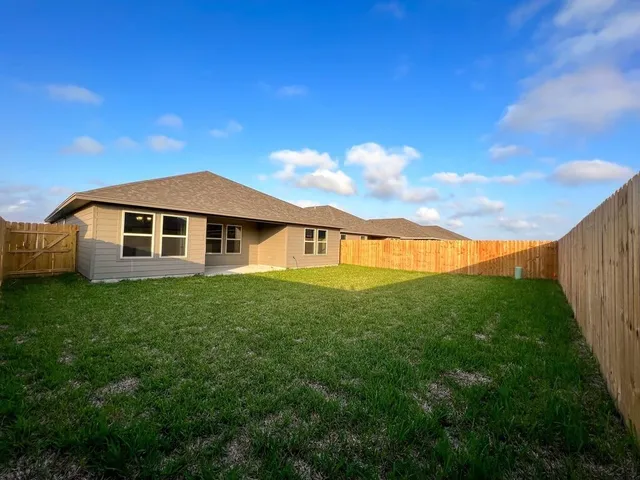 a view of an house with backyard space and garden